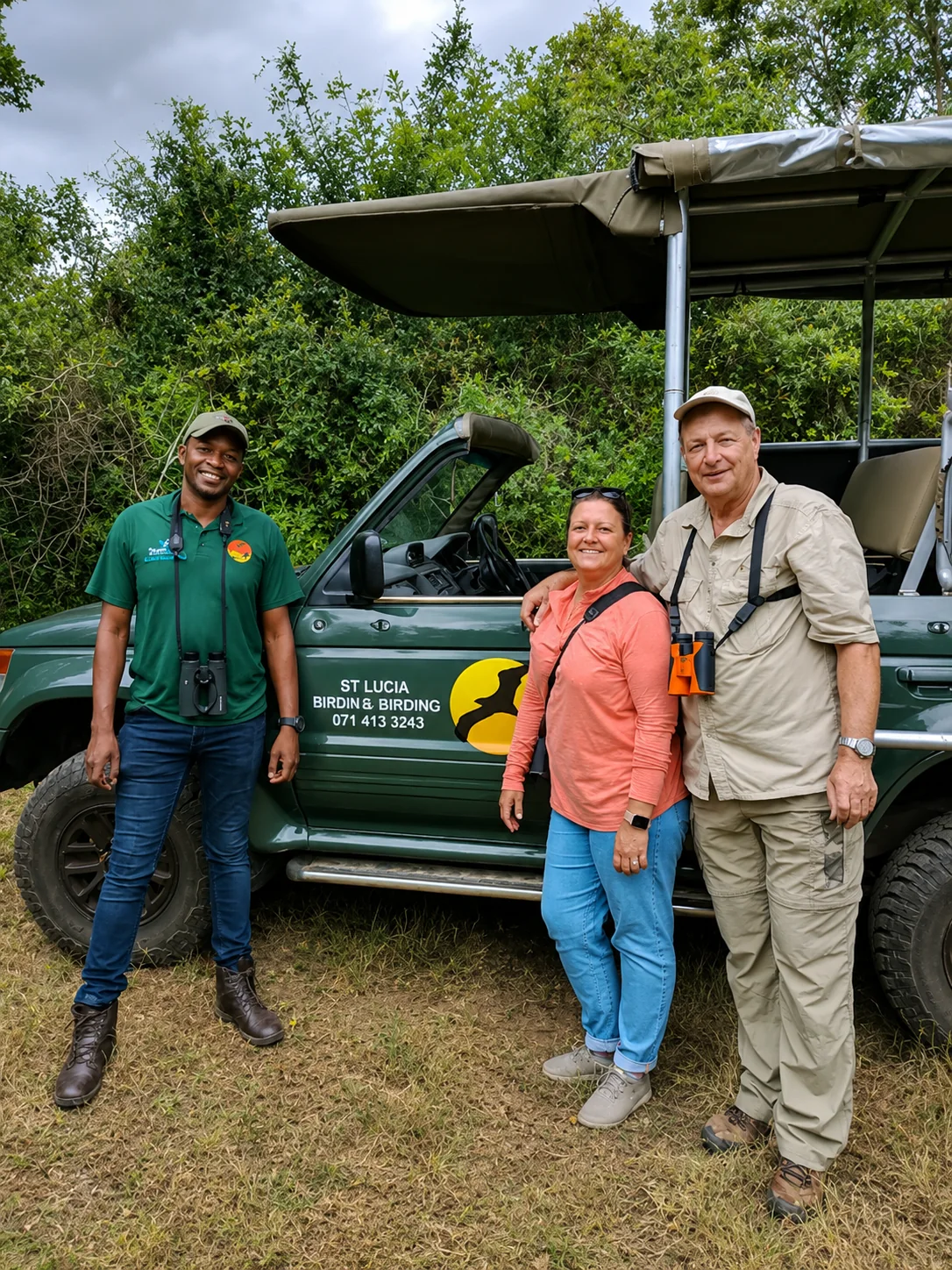 Guests with a local guide beside a birding safari vehicle